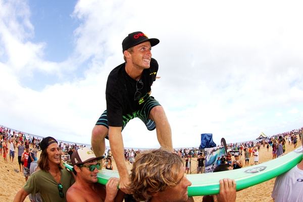 Sebastian Zietz (HAW), 24, surfs up the beach following his clinching of the 2012 Vans Hawaiian Triple Crown of Surfing.